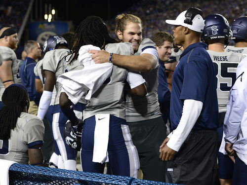 Scott Sommerdorf  |  The Salt Lake Tribune
USU teammates congratulate WR Devontae Robinson after he scored a TD to make the score 21-14. Utah State led BYU 28-14 at the half in Provo, Friday, October 1, 2014.