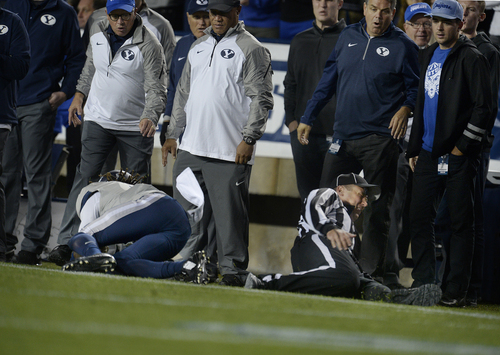 Scott Sommerdorf  |  The Salt Lake Tribune
A referee was injured and left the game on this play during the first half after getting caught from behind on a USU pass play. Utah State led BYU 28-14 at the half in Provo, Friday, October 1, 2014.