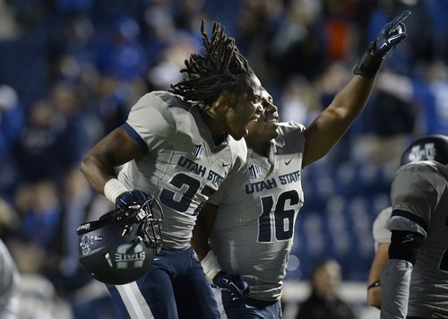 Scott Sommerdorf  |  The Salt Lake Tribune
Utah State Aggies safety Devin Centers, left, and teammate LB Anthony Williams celebrate the win over BYU. Utah State defeated BYU 35-20 in Provo, Friday, October 1, 2014.