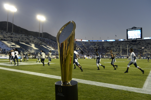 Scott Sommerdorf  |  The Salt Lake Tribune
The National Championship trophy was on display on the field during pre game warmups before BYU plays Utah State in Provo, Friday, October 1, 2014.