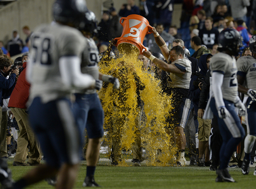 Scott Sommerdorf  |  The Salt Lake Tribune
Somewhere under this shower of Gatorade is USU head coach Matt Wells after the win over BYU. Utah State defeated BYU 35-20 in Provo, Friday, October 1, 2014.