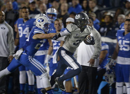 Scott Sommerdorf  |  The Salt Lake Tribune
Utah State Aggies wide receiver Devonte Robinson (3) rambles down the sideline with a pass during first half play. Utah State led BYU 28-14 at the half in Provo, Friday, October 1, 2014.