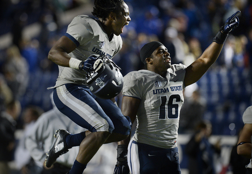 Scott Sommerdorf  |  The Salt Lake Tribune
Utah State Aggies safety Devin Centers, left, and teammate LB Anthony Williams celebrate the win over BYU. Utah State defeated BYU 35-20 in Provo, Friday, October 1, 2014.