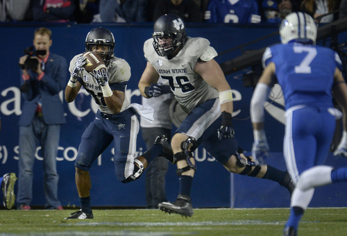 Scott Sommerdorf  |  The Salt Lake Tribune
Utah State Aggies running back Joe Hill runs the ball during first half play. Utah State led BYU 28-14 at the half in Provo, Friday, October 1, 2014.