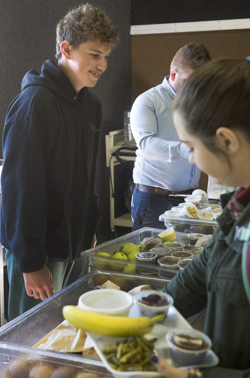 Rick Egan  |  The Salt Lake Tribune

Patrick Utzinger (left), helps out in the lunch line at City Academy in Salt Lake Thursday, Oct. 2, 2014. Utzinger, a senior at City Academy, is enrolled a job-training program for students with disabilities.