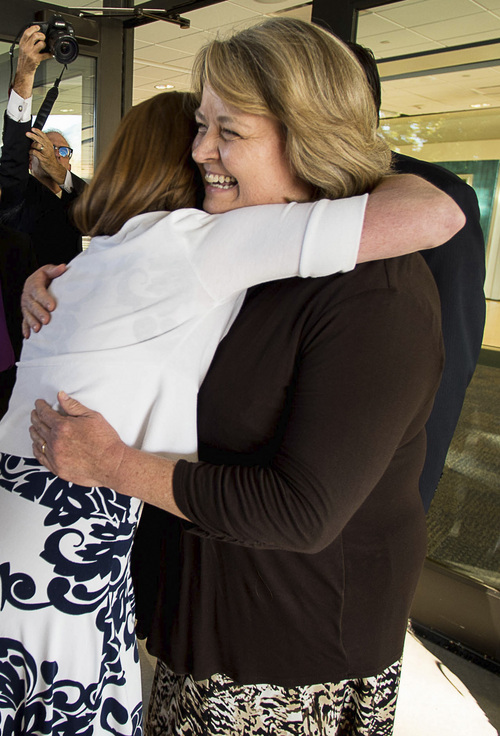 Trent Nelson  |  The Salt Lake Tribune
Abby Hansen, left, embraces Karen Roberts before leading a group of women through the door of BYU's Marriott Center to watch a broadcast of the LDS General priesthood session, in Provo Saturday October 4, 2014. Roberts and her husband Michael were volunteer ushers at the door assigned to meet the group and discourage, but not prevent the group from attending.