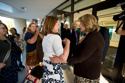 Trent Nelson  |  The Salt Lake Tribune
Abby Hansen, left, embraces Karen Roberts before leading a group of women through the door of BYU's Marriott Center to watch a broadcast of the LDS General Priesthood Session, in Provo Saturday October 4, 2014. Roberts and her husband Michael were volunteer ushers at the door assigned to meet the group and discourage, but not prevent the group from attending.