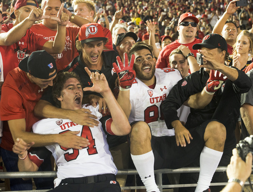 Rick Egan  |  The Salt Lake Tribune

Utah long snapper Chase Dominguez (94) and tight end Westlee Tonga (80) celebrate with Utah fans as the Utes held on for a 30-28 upset over UCLA in Pac-12 action at the Rose Bowl, Saturday, October 4, 2014