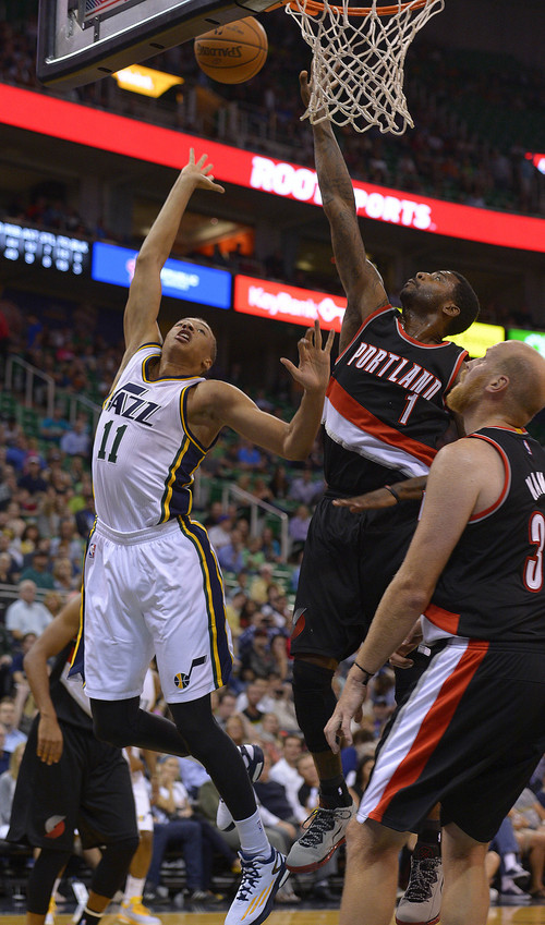 Leah Hogsten  |  The Salt Lake Tribune
Utah Jazz guard Dante Exum (11) floats to the net over Portland Trail Blazers forward Dorell Wright (1). Utah Jazz defeated the Portland Blazers 92-73 during Tuesday's, October 7, 2014 preseason opener at Energy Solutions Arena.