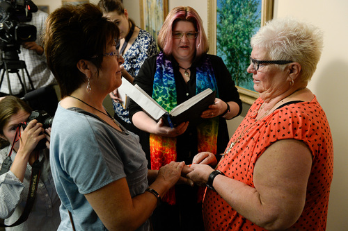 Francisco Kjolseth  |  The Salt Lake Tribune
Sheri Ault, left, and her partner of 18 years, Leslie McWilliams, are married by Reverend Heron (Tara Sudweeks Willgues) moments after getting their marriage license at the Salt Lake County Complex on Monday. The U.S. Supreme Court declined to review all five pending same-sex marriage cases on Monday, Oct. 6, 2014 effectively legalizing gay and lesbian unions, clearing the way for such marriages to proceed in 11 new states - including Utah.