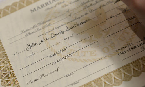 Francisco Kjolseth  |  The Salt Lake Tribune
A same-sex couple fills in their marriage certificate that reads Spouse 1 and Spouse 2 on Monday at the Salt Lake County Complex on Monday. The U.S. Supreme Court declined to review all five pending same-sex marriage cases on Monday, Oct. 6, 2014 effectively legalizing gay and lesbian unions, clearing the way for such marriages to proceed in 11 new states - including Utah.