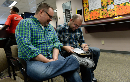 Francisco Kjolseth  |  The Salt Lake Tribune
Jason McDermaid, left, and Zachary Smallwood, who have been together for eight years, fill out a marriage license at the Salt Lake County Complex, becoming the second same-sex couple to show up on Monday morning. The U.S. Supreme Court declined to review all five pending same-sex marriage cases on Monday, Oct. 6, 2014 effectively legalizing gay and lesbian unions, clearing the way for such marriages to proceed in 11 new states - including Utah.