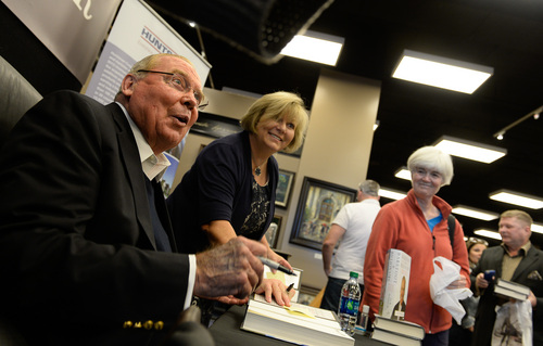 Francisco Kjolseth  |  The Salt Lake Tribune
Jon Huntsman Sr. signs copies of his new autobiography, "Barefoot to Billionaire," at a book signing at Deseret Book in downtown Salt Lake City on Friday, Oct. 3. 2014.