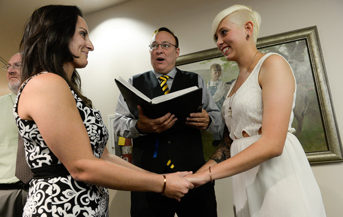 Francisco Kjolseth  |  The Salt Lake Tribune
Senator Jim Dabakis marries Yolanda Pascua, left, and Laekin Rogers on Monday at the Salt Lake County Complex. The U.S. Supreme Court declined to review all five pending same-sex marriage cases on Monday, Oct. 6, 2014 effectively legalizing gay and lesbian unions, clearing the way for such marriages to proceed in 11 new states - including Utah.