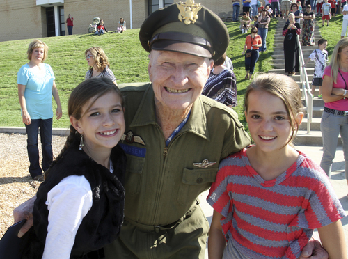 Rick Egan  | Tribune file photo 

Col. Gail Halvorsen, the "candy bomber" poses for a photo with Sabrina Plummer, and Lindsay Baird, students at Morgan Elementary where he dropped 800 candy bombs in a reenactment of the historical world event, Friday, September 7, 2012.