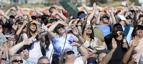 Al Hartmann  |  The Salt Lake Tribune
Overstock.com employees shade their eyes from the direct sun to see Overstock.com CEO Patrick Byrne's decent by parachute from 18,000 feet to the site for the company's ground breaking for a $100 million campus that it is calling the "Peace Coliseum," which will cover 230,793 square feet. It will look like a peace sign from overhead and the Roman Colosseum from the ground.  The parcel is on the northwest corner of the property at 7200 S. 900 West