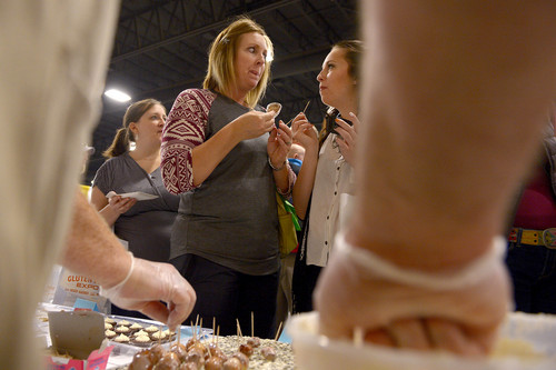 Leah Hogsten  |  The Salt Lake Tribune
"I'm kinda speechless right now," said Jennifer Paulsen, "because I'm thinking that Krispy Kreme has come to gluten free." Paulsen looks to her daughter Hannah Lipscomb as the two eat donut holes made from Gluten-Free Heaven products in Lehi, Saturday, October 11, 2014, at the Gluten Free Expo at the South Towne Expo Center.