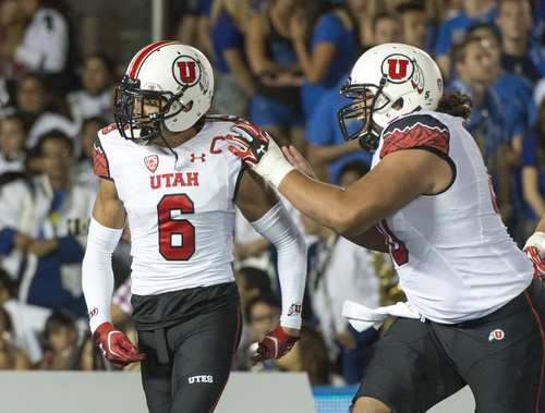 Rick Egan  |  The Salt Lake Tribune

Utah Utes offensive lineman Siaosi Aiono (60) congratulates Utah Ute's wide receiver Dres Anderson (6) after his touchdown, giving the Ute's a two touchdown lead over UCLA, at the Rose Bowl in Pasadena, Saturday, October 4, 2014