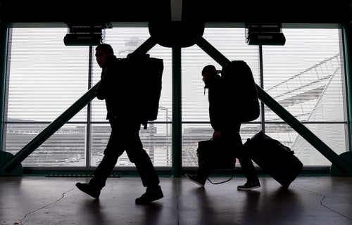 This Dec. 21, 2012 file photo shows travelers walking to a ticketing desk at O'Hare International Airport in Chicago. (AP Photo/Nam Y. Huh, File)