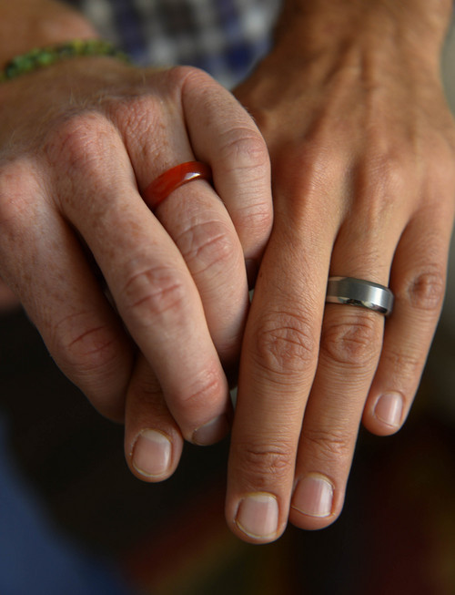 Leah Hogsten  |  The Salt Lake Tribune
l-r  Derek Kitchen and Moudi Sbeity, who met in October of 2009, are now engaged; one ring is made of carnelian, because Derek is allergic to metal and Moudi's is made of tungsten.  Plaintiffs in the now-closed case of Kitchen v. Herbert, Kitchen and Sbeity discuss the journey to marriage equality in Utah and what it's been like to be at the focal point of one of the highest-profile, history-making gay marriage cases in the country,Thursday, October 9, 2014 at their home in Salt Lake City. The same-sex plaintiffs' win at the 10th Circuit Court of Appeals was upheld when the U.S. Supreme Court declined to hear the stateís appeal.