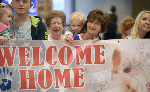 Al Hartmann  |  The Salt Lake Tribune
Family members of all ages wait with a banner for National Guard Sgt. Cameron Ashdown's arrival at the Salt Lake City International Airport Monday Ocotber 13, 2014. Fifty-two soldiers from two Utah National Guard units returned from Kosovo and Afghanistan on Monday. Forty-five soldiers returned from the 2nd Battalion, 211th Aviation from an 11-month deployment to Kosovo and seven soldiers from the 142nd Military Intelligence Battalion, after a seven-month deployment in Afghanistan.