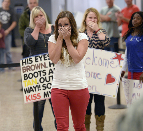 Al Hartmann  |  The Salt Lake Tribune
Halee Roberts is overcome with emotion upon seeing her husband Specialist Kendrick Roberts arrive at the Salt Lake City International Airport Monday Ocotber 13, 2014. They married in September 2013 but he was deployed two months later. The newlyweds have some catching up to do. 
 Fifty-two soldiers from two Utah National Guard units returned from Kosovo and Afghanistan on Monday. Forty-five soldiers returned from the 2nd Battalion, 211th Aviation from an 11-month deployment to Kosovo and seven soldiers from the 142nd Military Intelligence Battalion, after a seven-month deployment in Afghanistan.