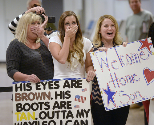 Al Hartmann  |  The Salt Lake Tribune
Family members of National Guardsman Specialist Kendrick Roberts are overcome with emotions upon seeing him arrive at the Salt Lake City International Airport Monday Ocotber 13, 2014.  His wife, Halee Roberts, center, married Kendrick last September but he was deployed two months later.  The newlyweds have some catching up to do. Fifty-two soldiers from two Utah National Guard units returned from Kosovo and Afghanistan on Monday. Forty-five soldiers returned from the 2nd Battalion, 211th Aviation from an 11-month deployment to Kosovo and seven soldiers from the 142nd Military Intelligence Battalion, after a seven-month deployment in Afghanistan.
