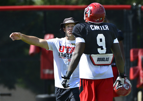Scott Sommerdorf   |  The Salt Lake Tribune
Utah safties coach Morgan Scalley talks with S Tevin Carter after a play at Utah football practice with pads on the baseball field, Thursday, August 7, 2014.