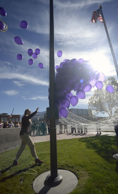 Al Hartmann  |  The Salt Lake Tribune
In honor of Domestic Violence Month, 272 purple balloons were released representing vicitms of domestic violence in Sandy last year in a ceremony Tuesday, October 14 at Sandy City Justice Court building.  The ceremony was to raise awareness and to remember the victims of domestic violence.