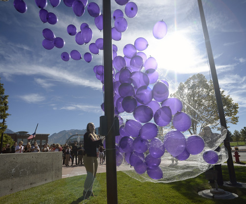 Al Hartmann  |  The Salt Lake Tribune
In honor of Domestic Violence Month, 272 purple balloons were released representing vicitms of domestic violence in Sandy last year in a ceremony Tuesday, October 14 at Sandy City Justice Court building.  The ceremony was to raise awareness and to remember the victims of domestic violence.