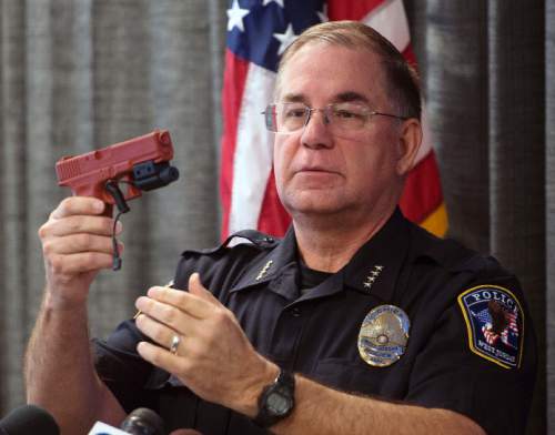 Steve Griffin  |  The Salt Lake Tribune


West Jordan Police Chief Doug Diamond demonstrats how a laser among device works after narrating the body camera video of an officer-involved shooting of Timothy Peterson on July 10, 2014 during a press conference at the West Jordan Justice Center in West Jordan, Utah Friday, October 3, 2014. Peterson was shot and wounded by police after pointing a metal bar, bent in the shape of a handgun, that had a laser pointer taped to the "barrel."