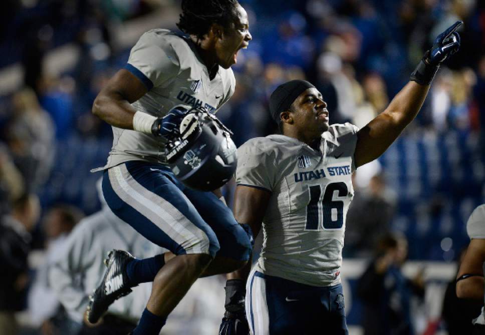 Scott Sommerdorf  |  The Salt Lake Tribune
Utah State Aggies safety Devin Centers, left, and team mate LB Anthony Williams celebrate the win over BYU. Utah State defeated BYU 35-20 in Provo, Friday, October 1, 2014.