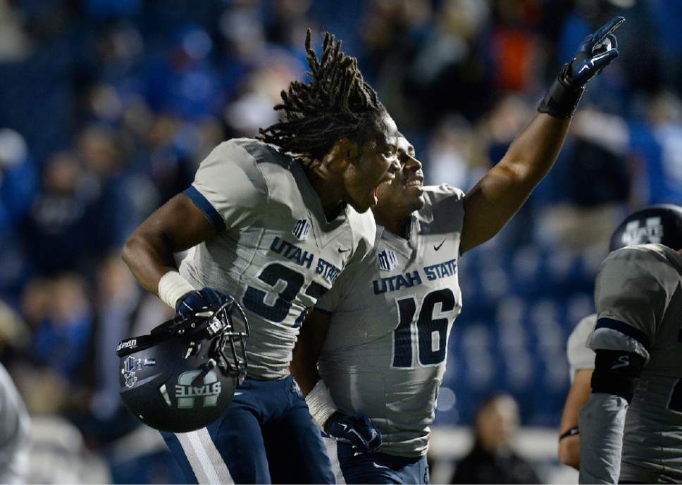 Scott Sommerdorf  |  The Salt Lake Tribune
Utah State Aggies safety Devin Centers, left, and team mate LB Anthony Williams celebrate the sion over BYU. Utah State defeated BYU 35-20 in Provo, Friday, October 1, 2014.