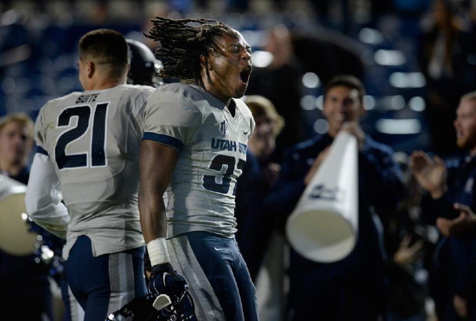 Scott Sommerdorf  |  The Salt Lake Tribune
Utah State Aggies safety Devin Centers (37) celebrates after the game ended and USU had beaten BYU. Utah State defeated BYU 35-20 in Provo, Friday, October 1, 2014.