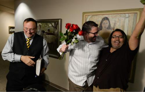 Francisco Kjolseth  |  The Salt Lake Tribune
Senator Jim Dabakis, left, officiates the marriage of Gregory Enke, center, and his partner of eight years Ariel Ulloa at the Salt Lake County Complex on Monday. The U.S. Supreme Court declined to review all five pending same-sex marriage cases on Monday, Oct. 6, 2014 effectively legalizing gay and lesbian unions, clearing the way for such marriages to proceed in eleven new states - including Utah.