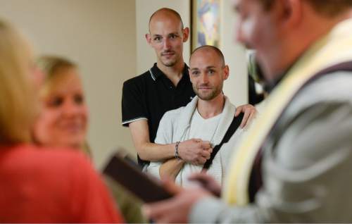 Francisco Kjolseth  |  The Salt Lake Tribune
Will Higgins, center left, and Kip Nielson who were married last year in Washington, embrace as they witness a same-sex marriage at the Salt Lake County Complex on Monday. The U.S. Supreme Court declined to review all five pending same-sex marriage cases on Monday, Oct. 6, 2014 effectively legalizing gay and lesbian unions, clearing the way for such marriages to proceed in eleven new states - including Utah.