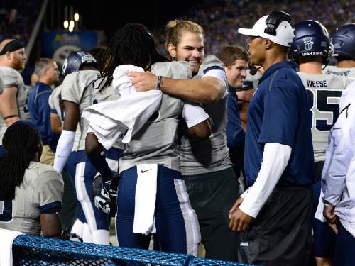 Scott Sommerdorf  |  The Salt Lake Tribune
USU team mates congratulate WR Devontae Robinson after he scored a TD to make the score 21-14. Utah State led BYU 28-14 at the half in Provo, Friday, October 1, 2014.