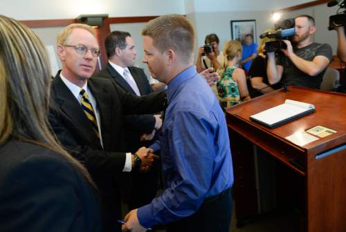 Francisco Kjolseth  |  The Salt Lake Tribune
Defense attorney Paul Cassell shakes hands with former West Valley City police officer Shaun Cowley after hearing from Judge L.A. Dever that he will not have to stand trial on Thursday, Oct. 9, 2014. Cowley was being charged with second-degree felony manslaughter in connection with the Nov. 2, 2012 fatal shooting of 21-year-old Danielle Willard.