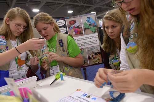 Leah Hogsten  |  The Salt Lake Tribune
l-r Jessie Buss of Orem and Cianna Penman of Sunset create necklaces and bookmarks at the JoAnn Fabrics booth at the National Girl Scout Convention at the Salt Palace Convention Center in Salt Lake, October 16, 2014. The "Hall of Experiences," part of the National Girl Scout Convention, includes more than 70 interactive and educational activities including women of the Harlem Globetrotters, LPGA mini-golf, the U.S. Space and Rocket Center camp and a 25-foot-high treehouse.