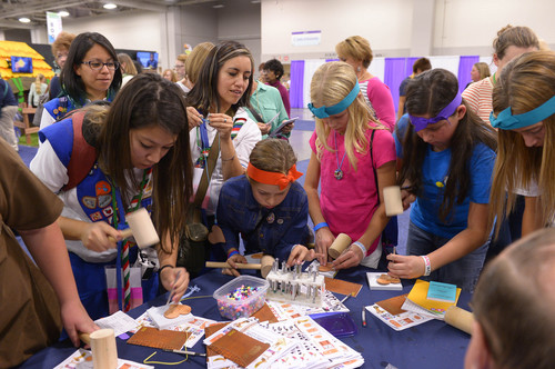 Leah Hogsten  |  The Salt Lake Tribune
Girl Scouts hammer prints and holes into leather crafts at the National Girl Scout Convention at the Salt Palace Convention Center in Salt Lake, October 16, 2014. The "Hall of Experiences," part of the National Girl Scout Convention, includes more than 70 interactive and educational activities including women of the Harlem Globetrotters, LPGA mini-golf, the U.S. Space and Rocket Center camp and a 25-foot-high treehouse.