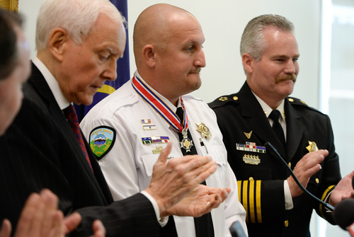 Francisco Kjolseth  |  The Salt Lake Tribune
Senators Mike Lee and Orrin Hatch and Sheriff Terry Thompson, at right,  present Lt. Nathan Hutchinson, in white, from the Weber County Sheriff's Office with the State and Local Law Enforcement Congressional Badge of Bravery Award. On Jan. 4, 2012, Hutchinson responded to the extremely dangerous and violent confrontation that took place between a suspect and members of the Weber Morgan Narcotic Strike Force that were attempting to execute a knock-and-announce search warrant in Ogden. In the shootout that ensued Hutchinson physically dragged agent Kasey Burrell out of the home safely despite being fired upon and being wounded.