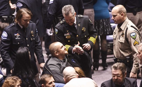 Leah Hogsten | Tribune file photo  
Weber County Sheriff's Sgt. Nate Hutchinson, injured in the drug raid shakes the hand of Weber County Sheriff Terry Thompson (center). Joined by law enforcement officers statewide, the family and friends of slain Ogden police Officer Jared Francom said farewell during Wednesday, January 11, 2012 funeral services at Weber State University's Dee Events Center. Francom, the 30-year-old father of two young girls, was gunned down during a drug raid on an Ogden home the night of Jan. 4. Five other officers also were wounded in a hail of gunfire that erupted as the Weber-Morgan Narcotics Strike Force attempted to serve a "knock and announce" search warrant on the residence of Matthew David Stewart.