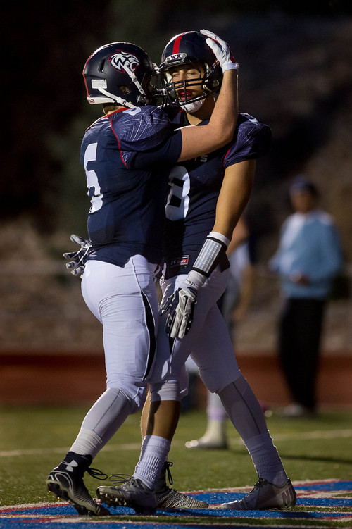 Trent Nelson  |  The Salt Lake Tribune
Woods Cross's Keadon Adamson, left, and Cole Cappellucci celebrate Cappellucci's first quarter touchdown as Woods Cross hosts Corner Canyon High School football, in Woods Cross, Wednesday October 15, 2014.