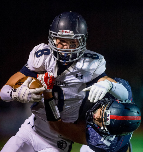 Trent Nelson  |  The Salt Lake Tribune
Corner Canyon's Jake Cahoon is brought down by Woods Cross's Keith Saylin as Woods Cross hosts Corner Canyon High School football, in Woods Cross, Wednesday October 15, 2014.