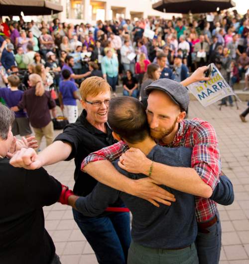 Trent Nelson  |  The Salt Lake Tribune
Debbie Johnson rushes in to embrace Kitchen v. Herbert plaintiffs Derek Kitchen and Moudi Sbeity at a rally to celebrate today's legalization of same-sex marriage, Monday October 6, 2014 in Salt Lake City.