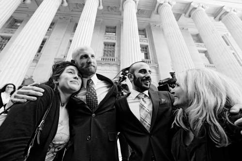Plaintiff and gay rights activist Derek Kitchen, center left, hugs his cousin Amelia Davis, left, as Derek's partner Moudi Sbeity hugs his mother Joni Jensen, after leaving court following a hearing at the U.S. Circuit Court of Appeals in Denver, Thursday, April 10, 2014. The court is to decide if it agrees with a federal judge in Utah who in mid-December overturned a 2004 voter-passed gay marriage ban, saying it violates gay and lesbian couples' rights to due process and equal protection under the 14th Amendment. (AP Photo/Brennan Linsley)