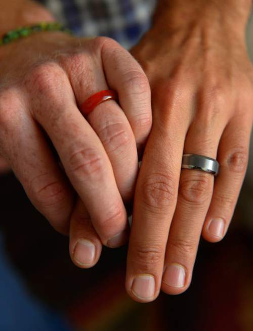 Leah Hogsten  |  The Salt Lake Tribune
l-r  Derek and Moudi who met in October of 2009 are now engaged; one ring is made of carnelian, because Derek is allergic to metal and Moudi's is made of tungsten.  Plaintiffs in the now-closed case of Kitchen v. Herbert,  Derek Kitchen and  Moudi Sbeity discuss the journey to marriage equality in Utah and what it's been like to be at the focal point of one of the highest-profile, history-making gay marriage cases in the country,Thursday, October 9, 2014 at their home in Salt Lake City. The same-sex plaintiffs, whose win at the 10th Circuit Court of Appeals was upheld when the U.S. Supreme Court declined to hear the state's appeal.