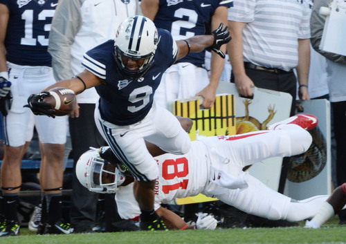 Steve Griffin  |  The Salt Lake Tribune


BYU Cougars wide receiver Jordan Leslie (9) tries to escape the tackle of Houston Cougars defensive back Lee Hightower (18) during game between BYU and Houston and LaVell Edwards Stadium in Provo, Thursday, September 11, 2014.