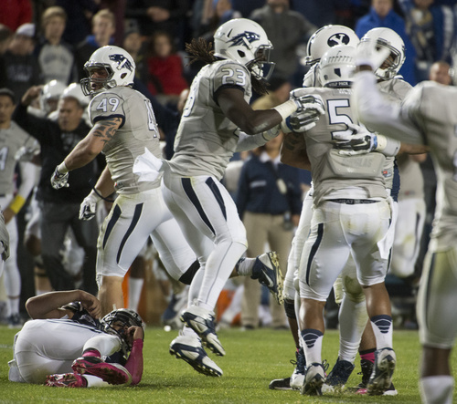 Rick Egan  |  The Salt Lake Tribune

Brigham Young Cougars quarterback Christian Stewart (7) lies on the ground as Nevada Wolf Pack celebrates after recovering Stewart's fumble with 39 seconds left in the game, and Nevada up 42-35, in football action, BYU vs The Nevada Wolf Pack at LaVell Edwards Stadium, Saturday, October18, 2014