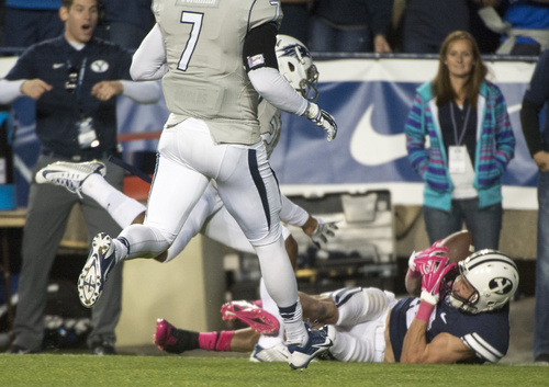 Rick Egan  |  The Salt Lake Tribune

 Brigham Young Cougars wide receiver Mitch Mathews (10) hangs on to the ball as he hauls in a pass for a touchdown, in football action, BYU vs The Nevada Wolf Pack at Lavell Edwards Stadium, Saturday, October18, 2014